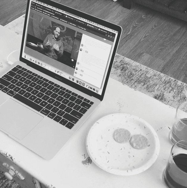 Online church service on laptop with a pastor speaking, digital worship, community faith gathering.